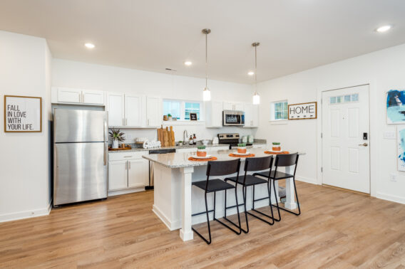 Apartment kitchen furnished with stainless steel appliances